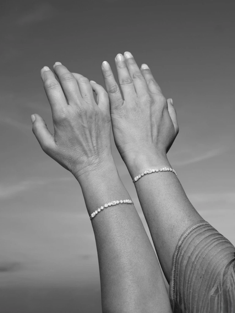 Both hands comparing bracelets