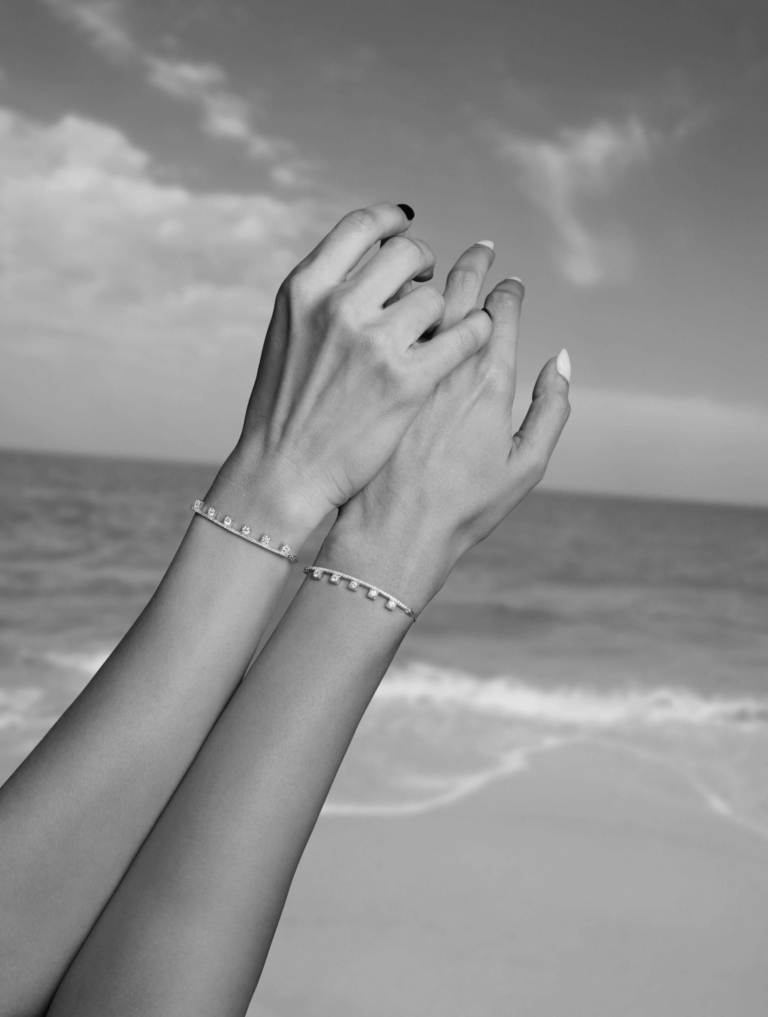 Hands showing their bracelets