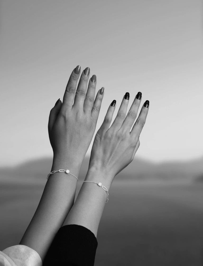 Two hands with their bracelets