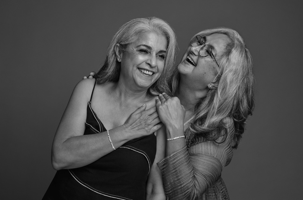 Black and white shot of two best friends wearing matching natural diamond bracelets