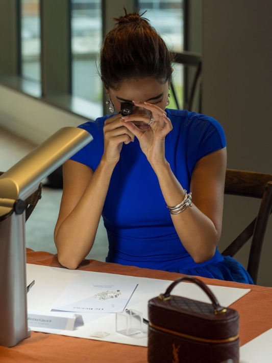 Ananya Panday using a scope to examine a rough diamond