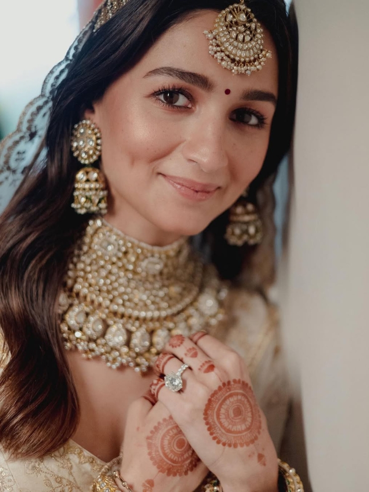 Close up shot of Alia Bhatt wearing a natural diamond engagement ring on her wedding