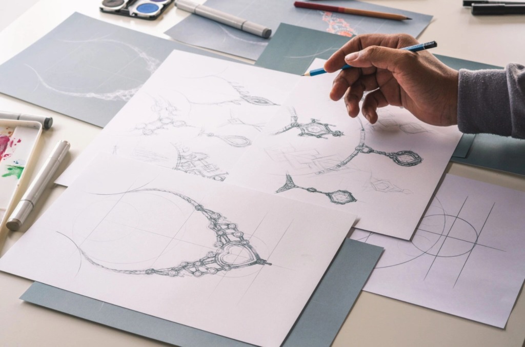 A person making a sketch of custom natural diamond jewellery