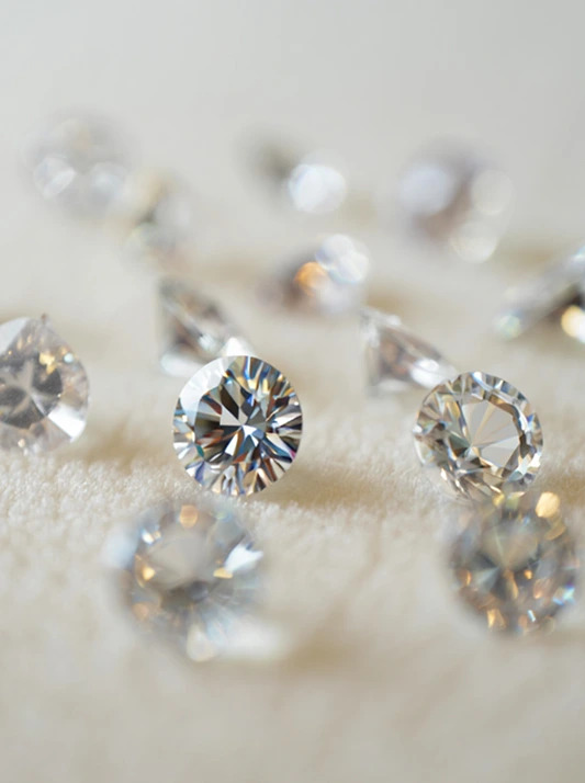 Well-cut natural diamonds on a cream surface