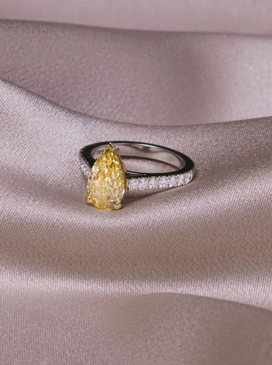A brilliant ring featuring a desert diamond solitaire and small natural diamonds