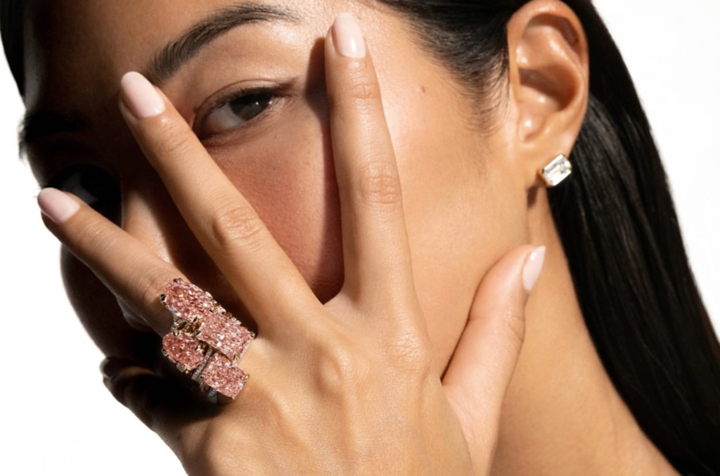 Woman wearing ring with coloured diamonds