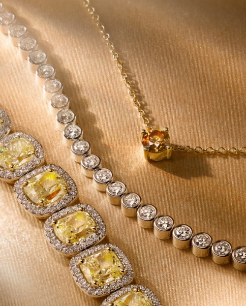 Diamond jewellery laid out on a fabric surface