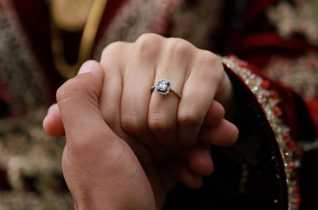 Close up of a bride's hand wearing a diamond ring