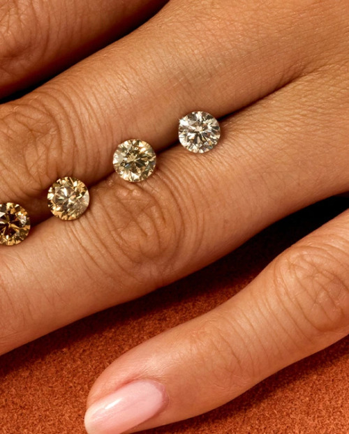 Close up of a hand dotted with five shades of Desert diamonds
