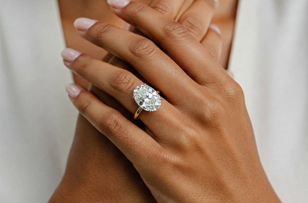 Close up of a hand featuring a natural diamond solitaire ring