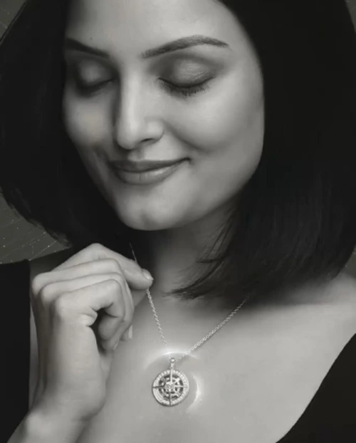 A woman wearing a diamond necklace