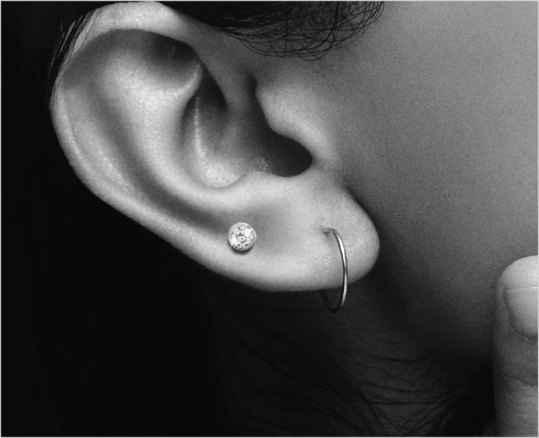 Close up of an ear with a diamond stud as a second piercing