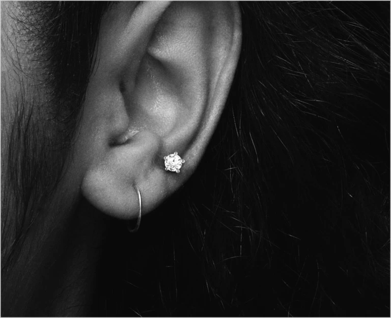 Close up of an ear with a diamond stud as a second piercing