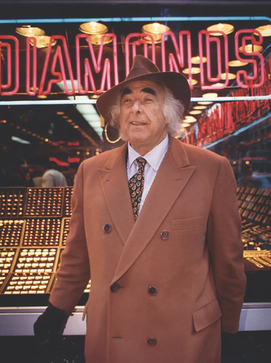 Famed diamantaire William Goldberg in a brown suit and hat