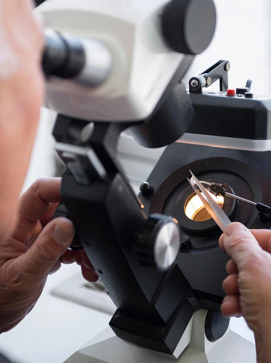 A diamond being examined under a microscope