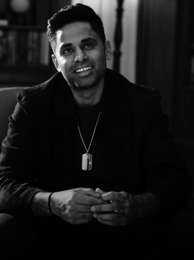 A black and white image of cricketer Suryakumar Yadav wearing a custom De Beers diamond pendant