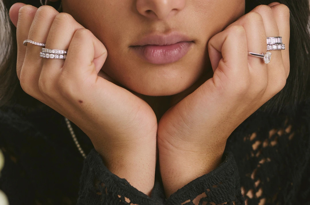 Close up of a woman wearing diamond stacked rings