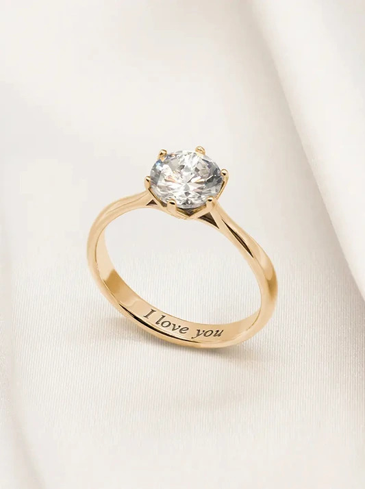 A diamond ring with a personalised engraving that says 'I love you'