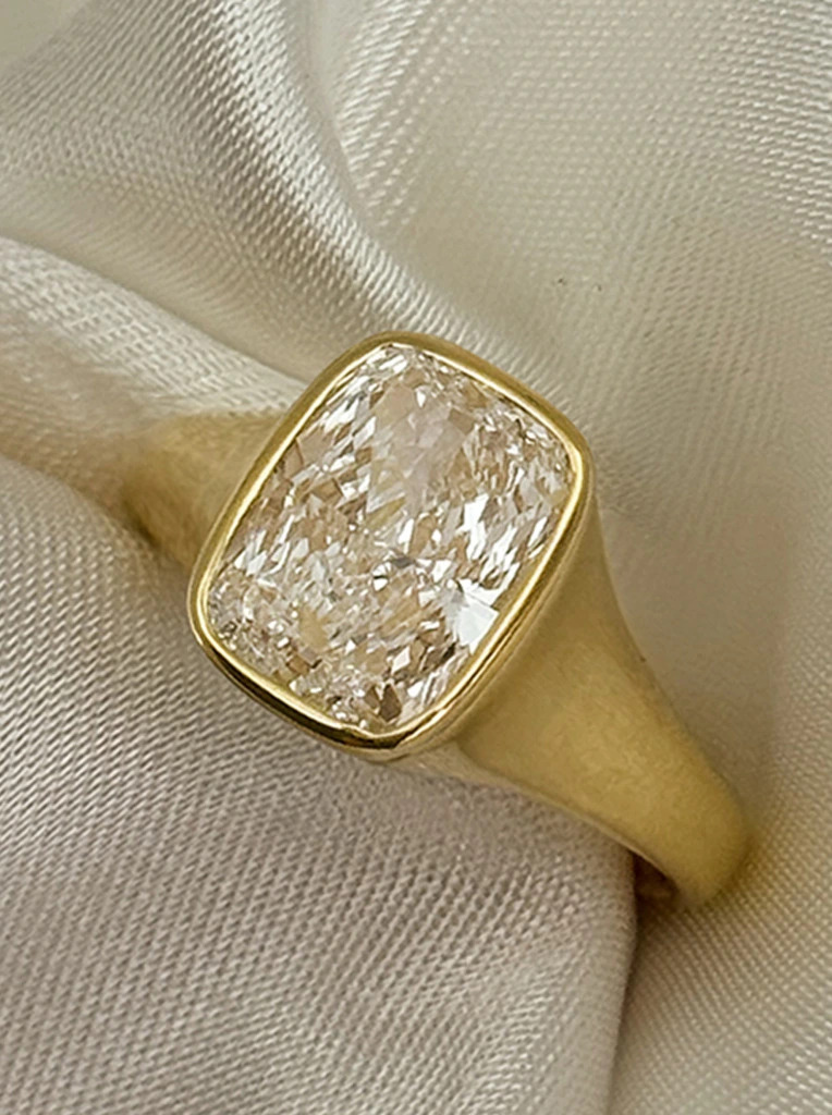 Close up of a solitaire diamond ring in a bezel setting