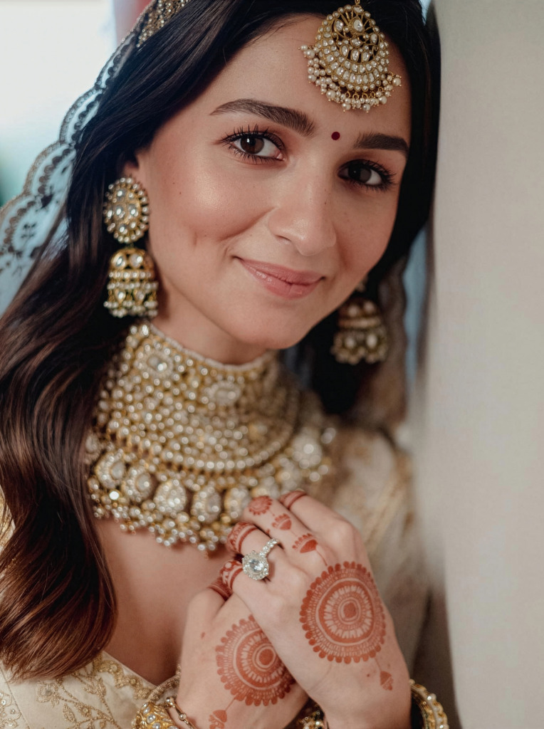 Alia Bhatt in bridal wear showing her diamond engagement ring