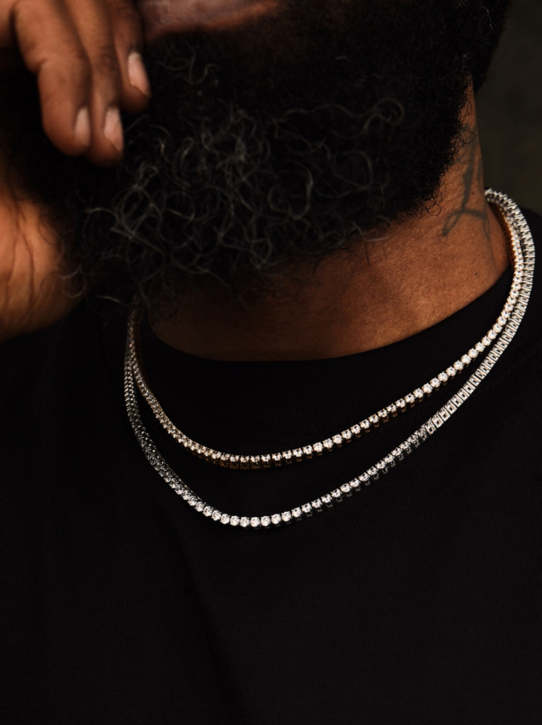 A man wearing layered diamond necklaces