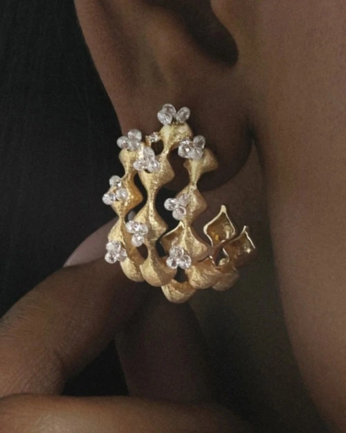 Close up of a sculptural natural diamond earring