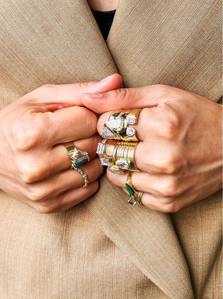 Woman with gold and diamond rings on each of her fingers