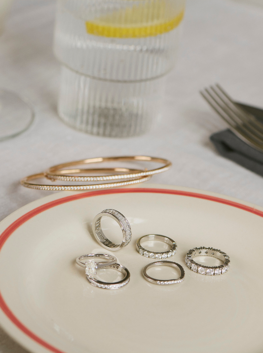 A selection of diamond rings in white gold on a saucer