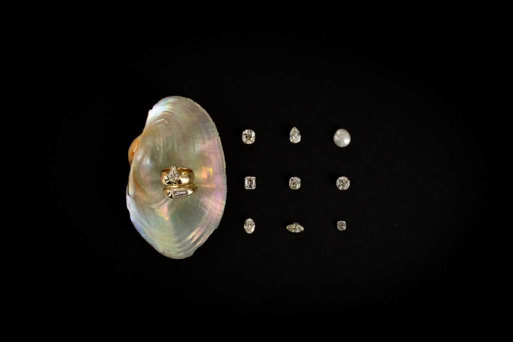 Different gems of WWAKE jewelry on a black background