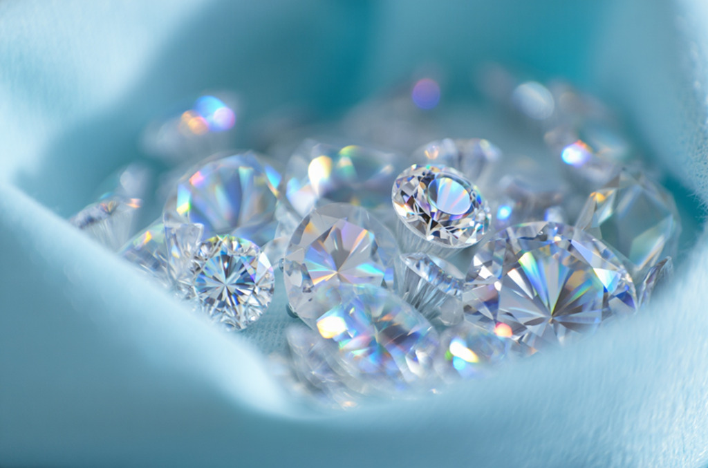 A group of shimmering white cut diamonds in blue cloth