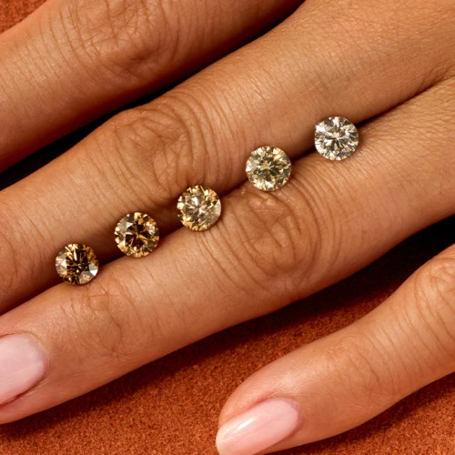 Olive hand on orange background with ombre of cut desert diamonds