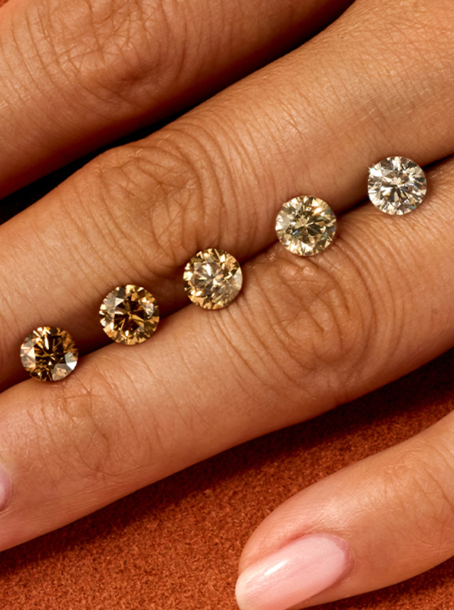 Olive hand on orange background with ombre of cut desert diamonds