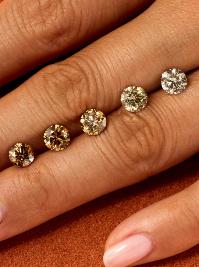 Olive hand on orange background with ombre of cut desert diamonds