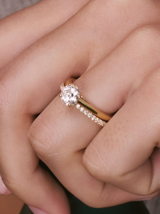 A a simple solitaire diamond on a yellow gold band