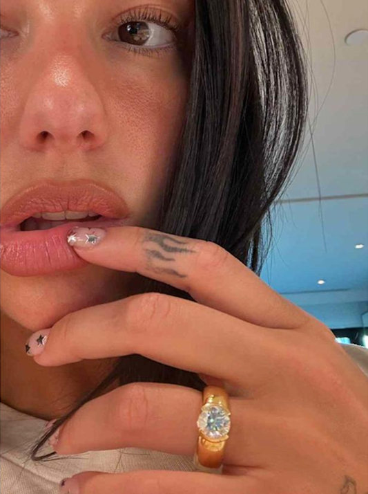 Dua Lipa wearing a natural diamond engagement ring