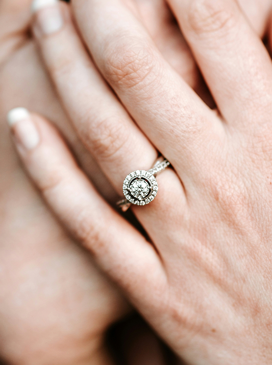 A natural diamond engagement ring featuring a halo design