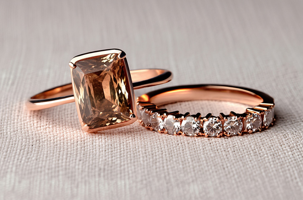 A radiant-cut Whiskey Desert diamond ring set in rose gold beside a diamond eternity band, showcasing the gem’s warmth and modern elegance.