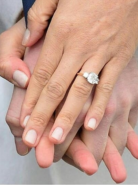 Meghan Markle's natural diamond engagement ring featuring a center stone from Botswana, flanked by two smaller diamonds from Princess Diana’s collection.