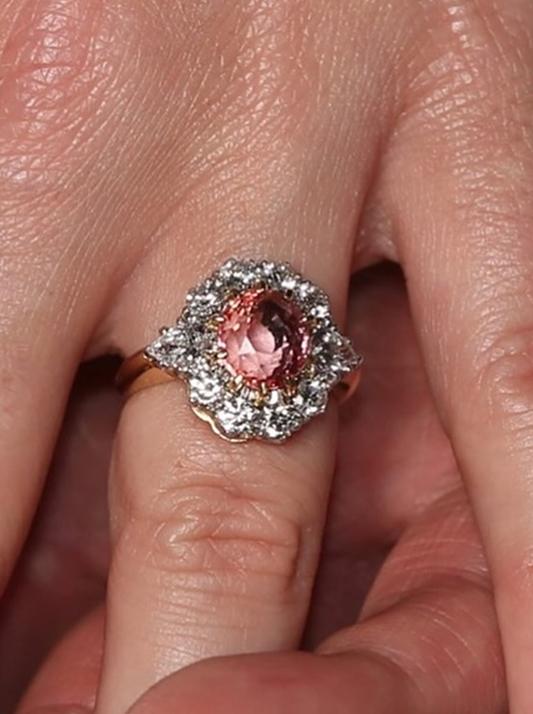 Princess Eugenie's engagement ring featuring a padparadscha sapphire surrounded by a halo of natural diamonds.