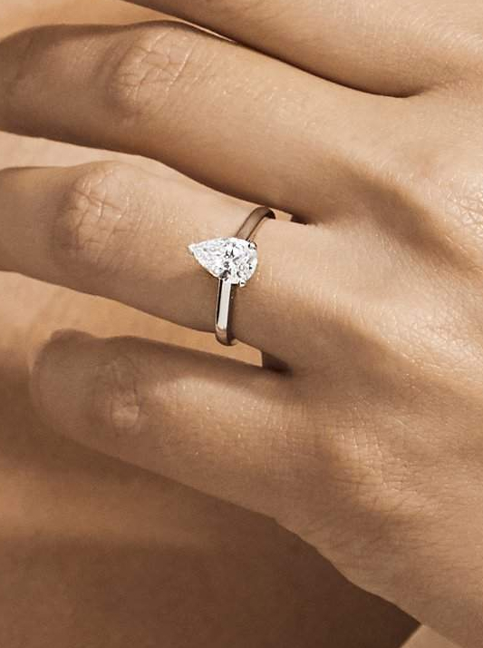 A solitaire engagement ring with a pear-shaped diamond