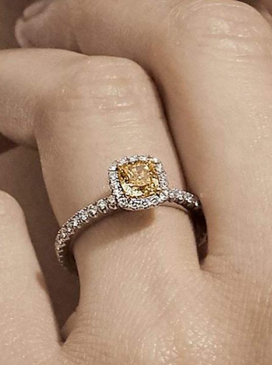 A halo-style engagement ring with a Desert diamond
