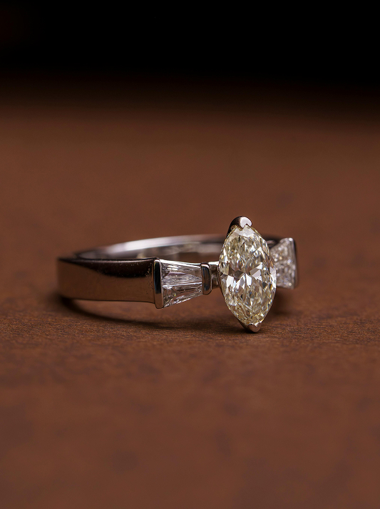 A diamond engagement ring with a marquise diamond at the centre