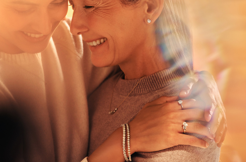A mother and daughter wearing sets of beautiful diamond jewelry