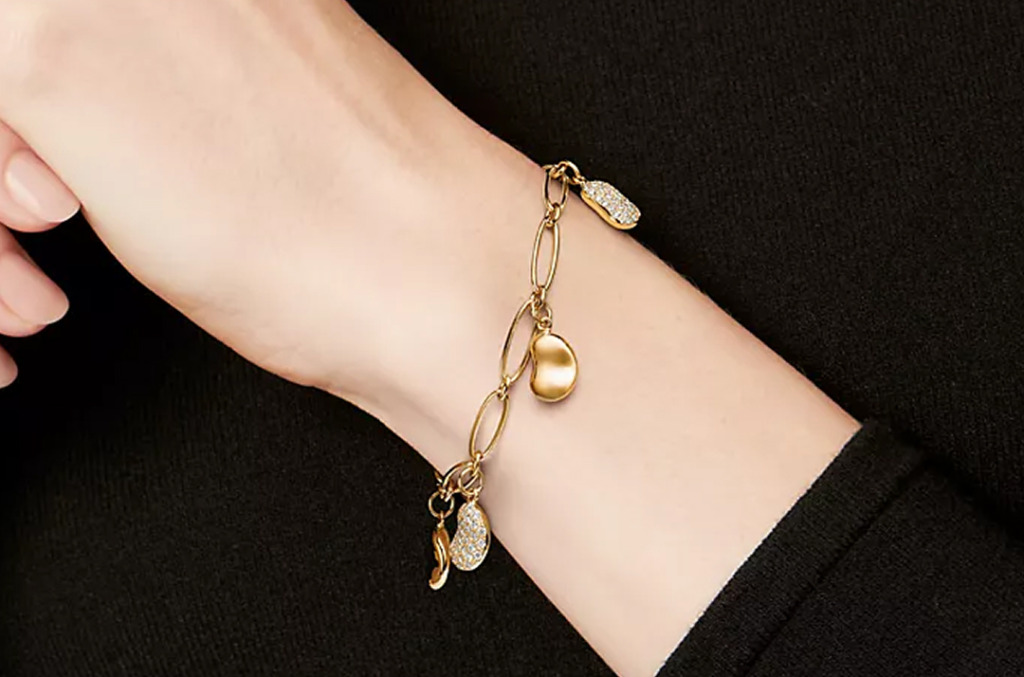 A gold charm bracelet featuring natural diamond charms 