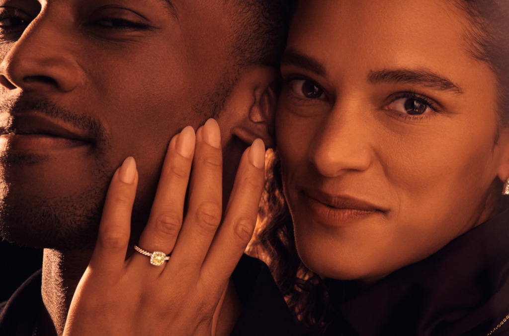 A newly engaged couple showing off a natural diamond engagement ring 