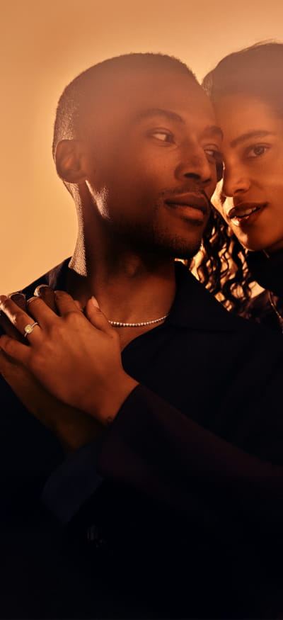 A couple in embrace wearing desert diamonds.
