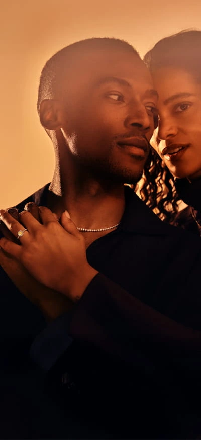 A couple in embrace wearing desert diamonds.