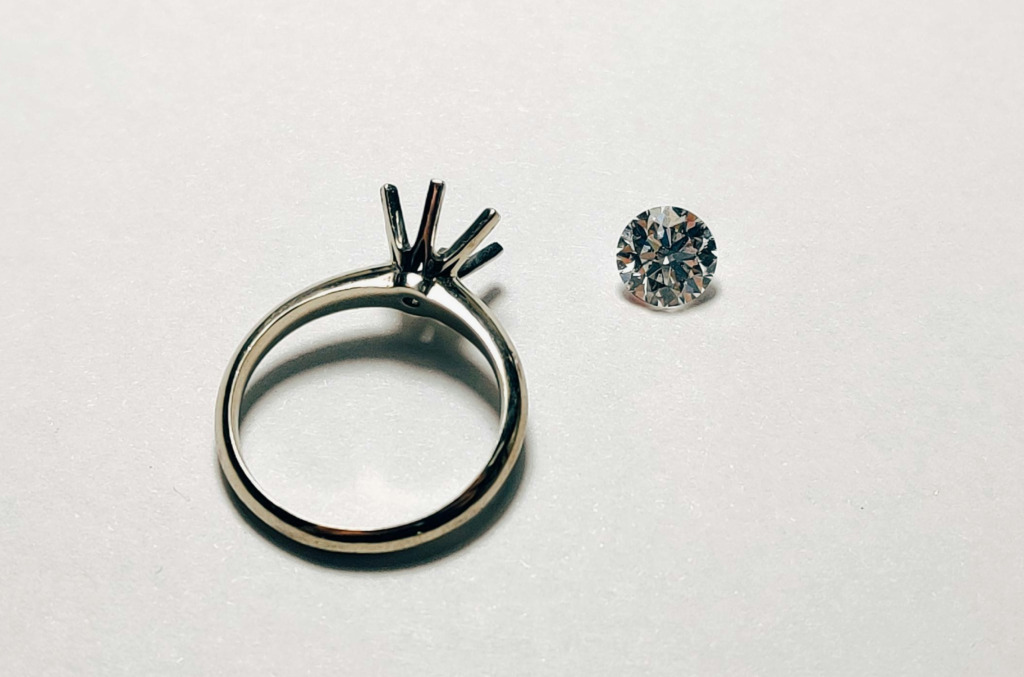 Article 55 How To Buy An Engagement Ring Image 2  Diamond Being Placed Into A Ring Image Unsplash