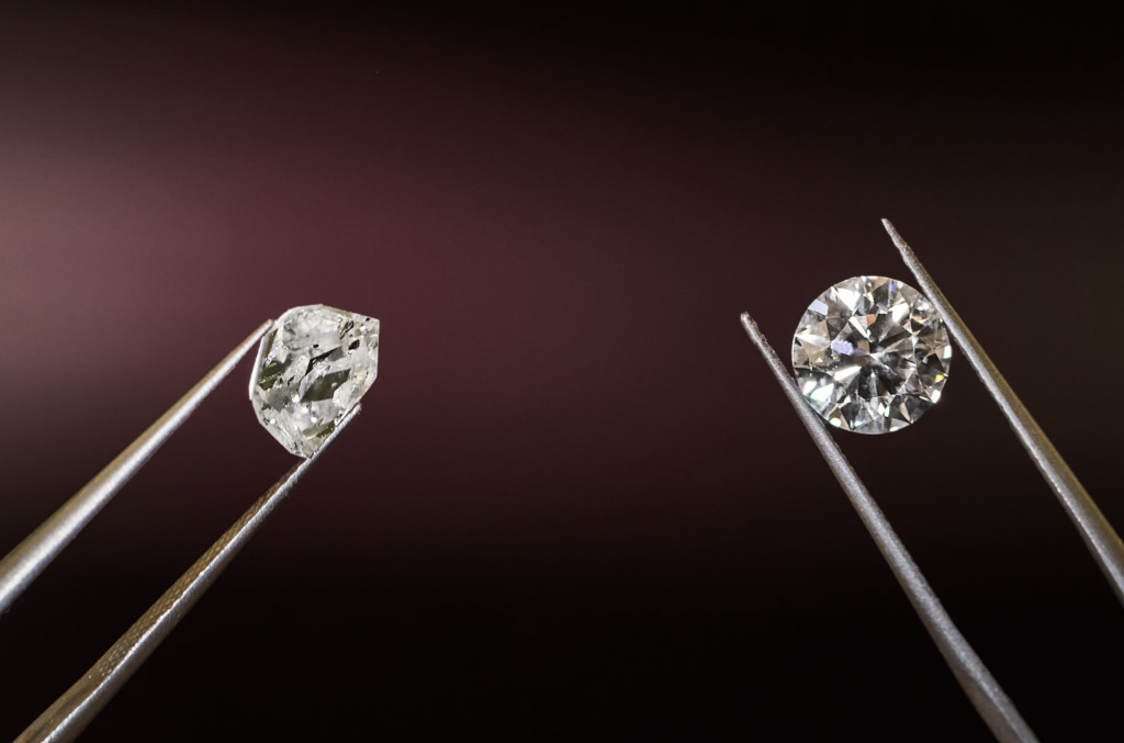 A rough, uncut natural crystal next to its polished counterpart
