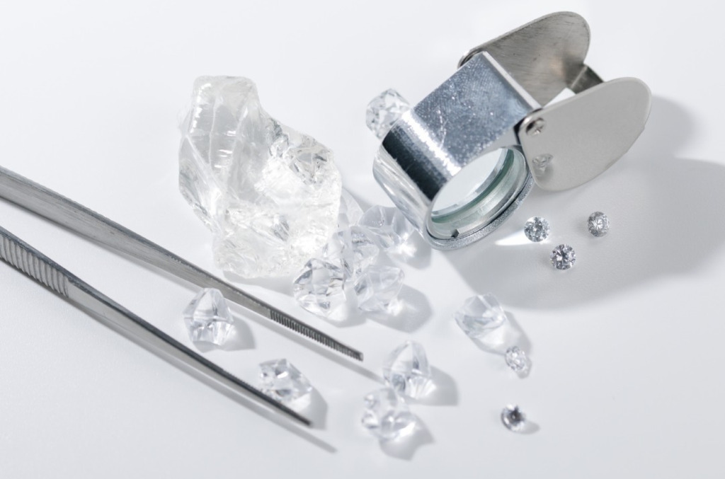 rough to polished loose natural diamonds being examined